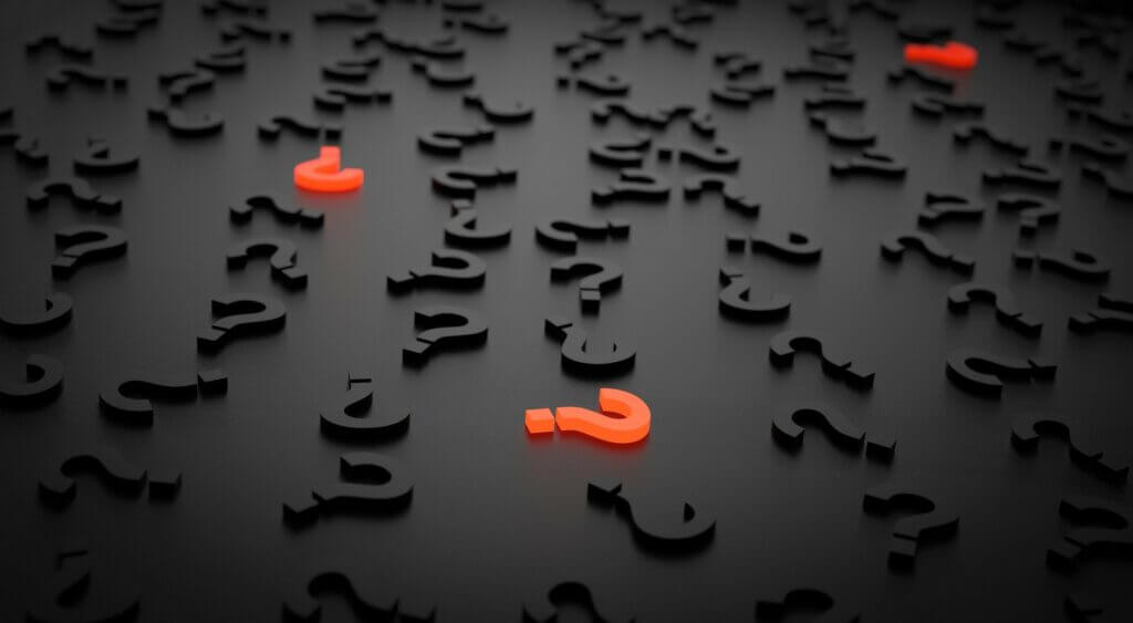 Black questions marks with red question mark - considering digital telecare blog.