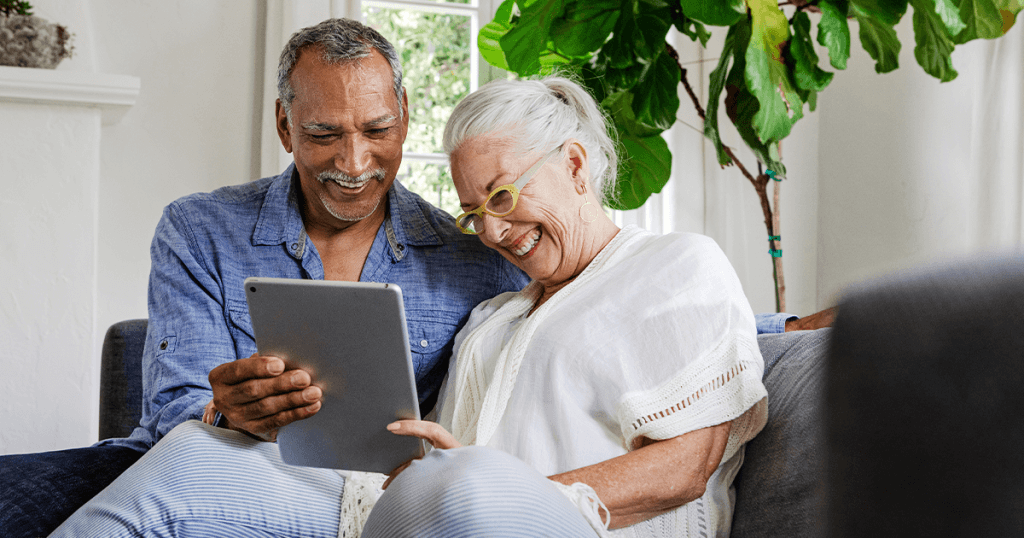 Two elderly people looking at tablet - digital telecare
