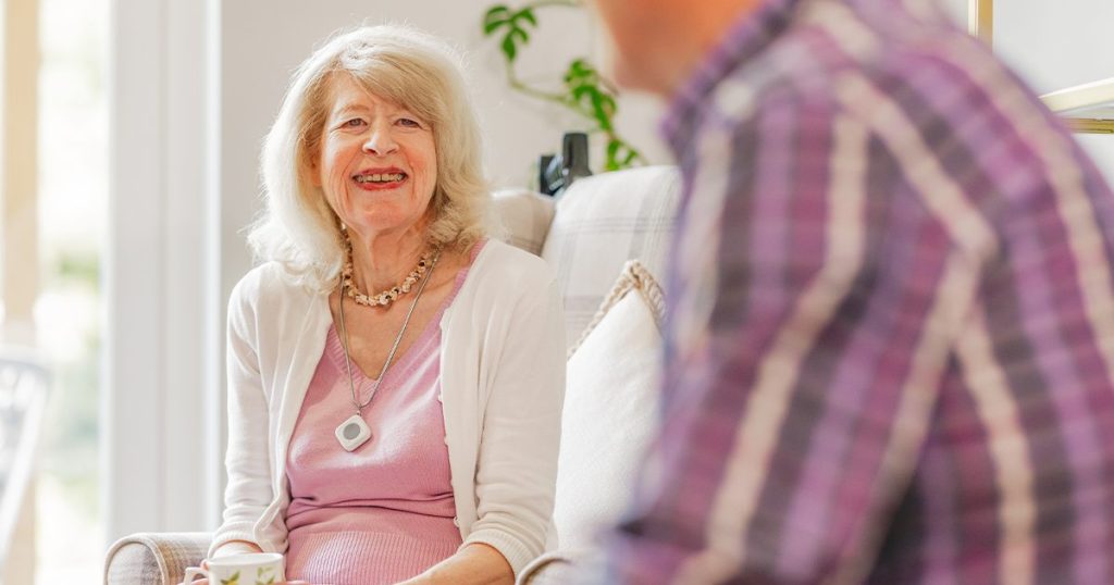 Two elderly people sat in lounge