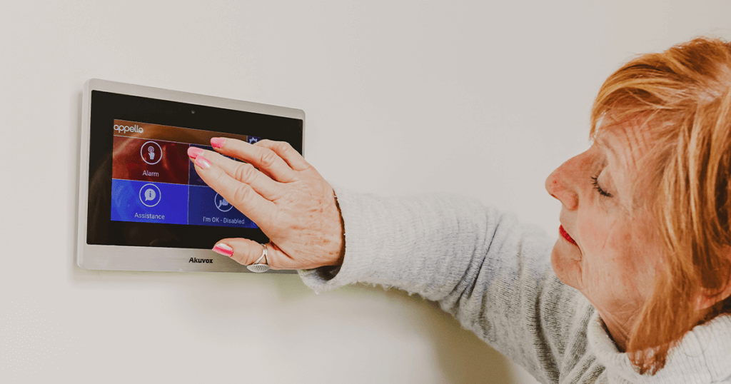 Woman using her warden call system