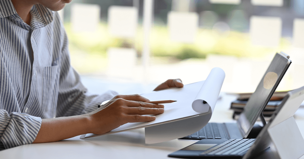 Woman sat looking at laptop building a business case.