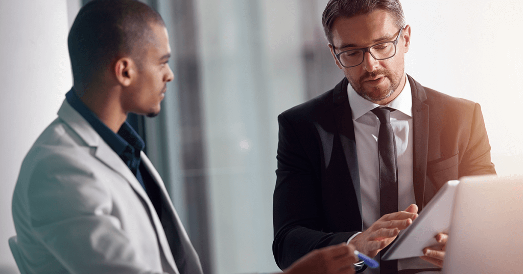 Two men in suits discussing digital telecare
