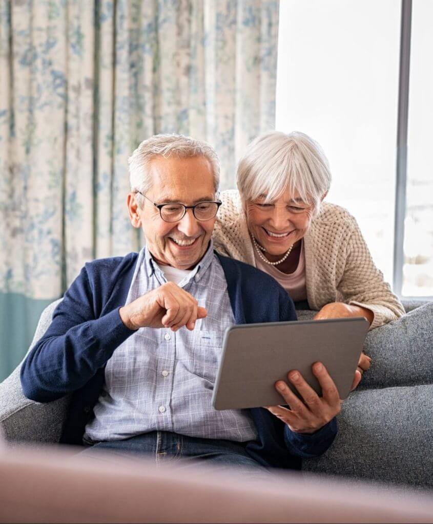 Senior couple using digital tablet for a video call with family