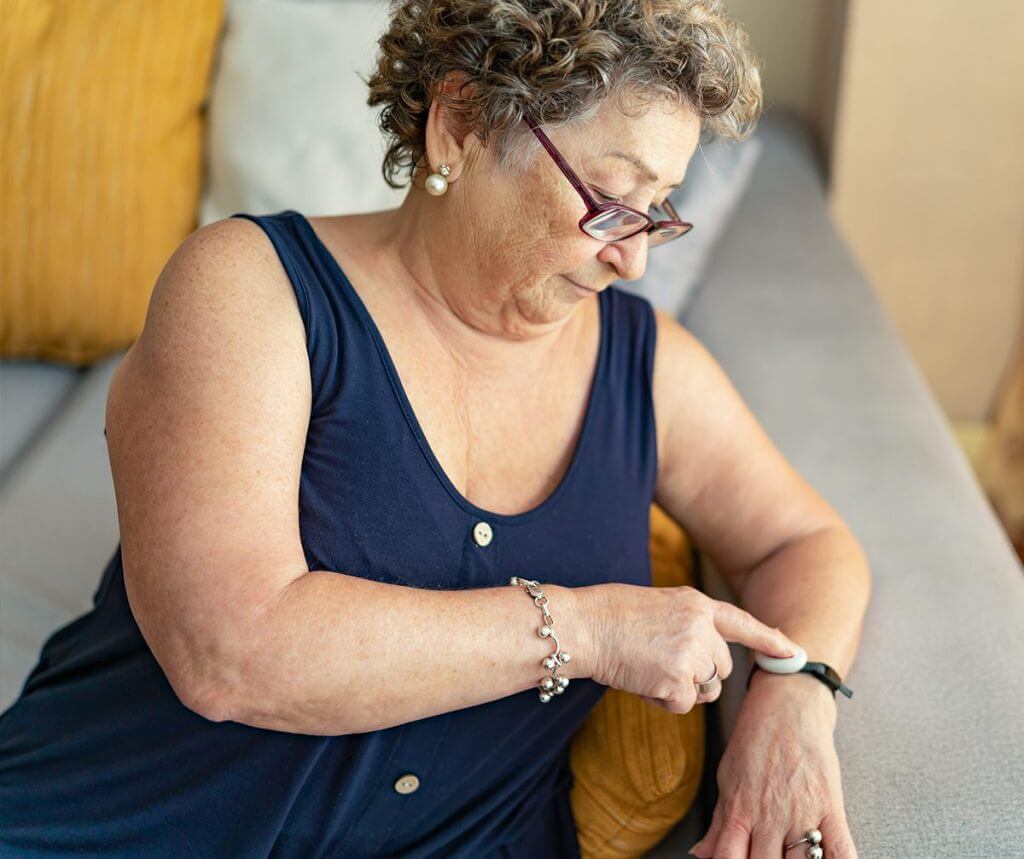 Woman using her pendant to call for help