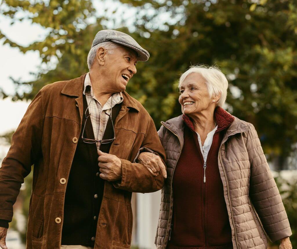 Two elderly people walking together