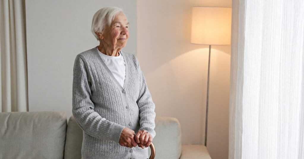 Old woman looking out the window